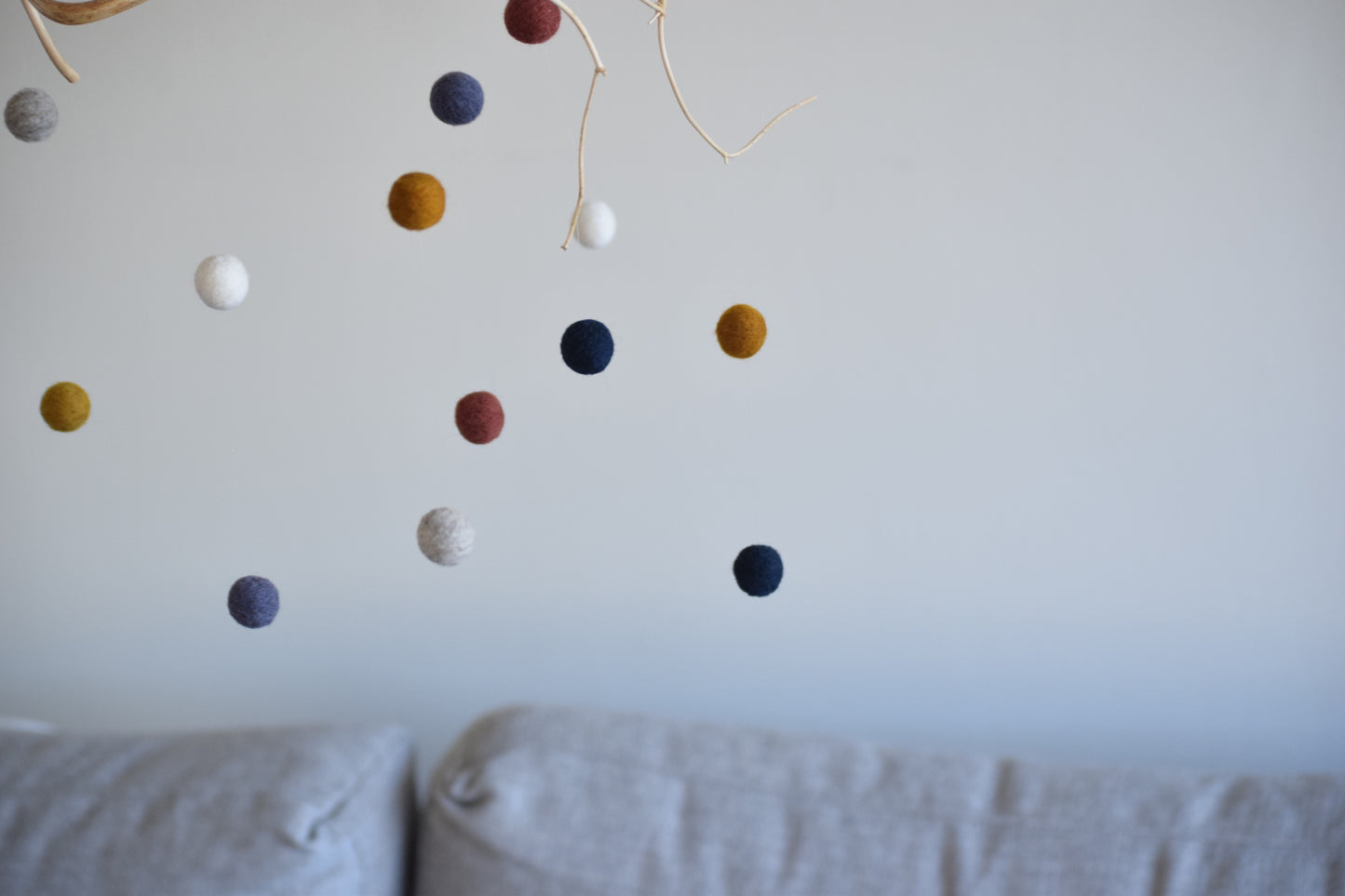 Móvil de rama con pelotitas de colores